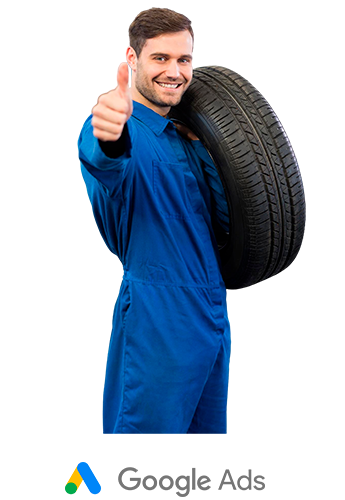 Profissional de macacão azul carregando um pneu no ombro